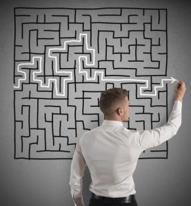 Businessman finding the solution of a maze